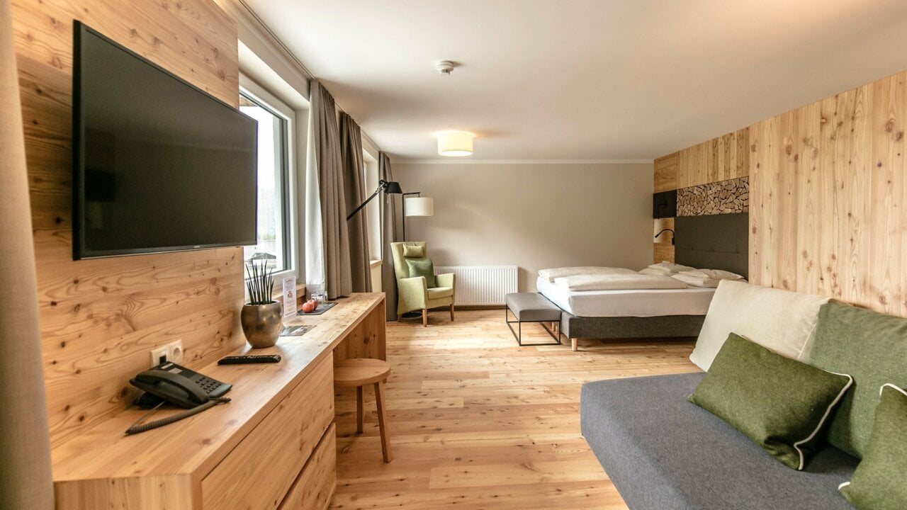 Modern hotel room with wooden decor and amenities
